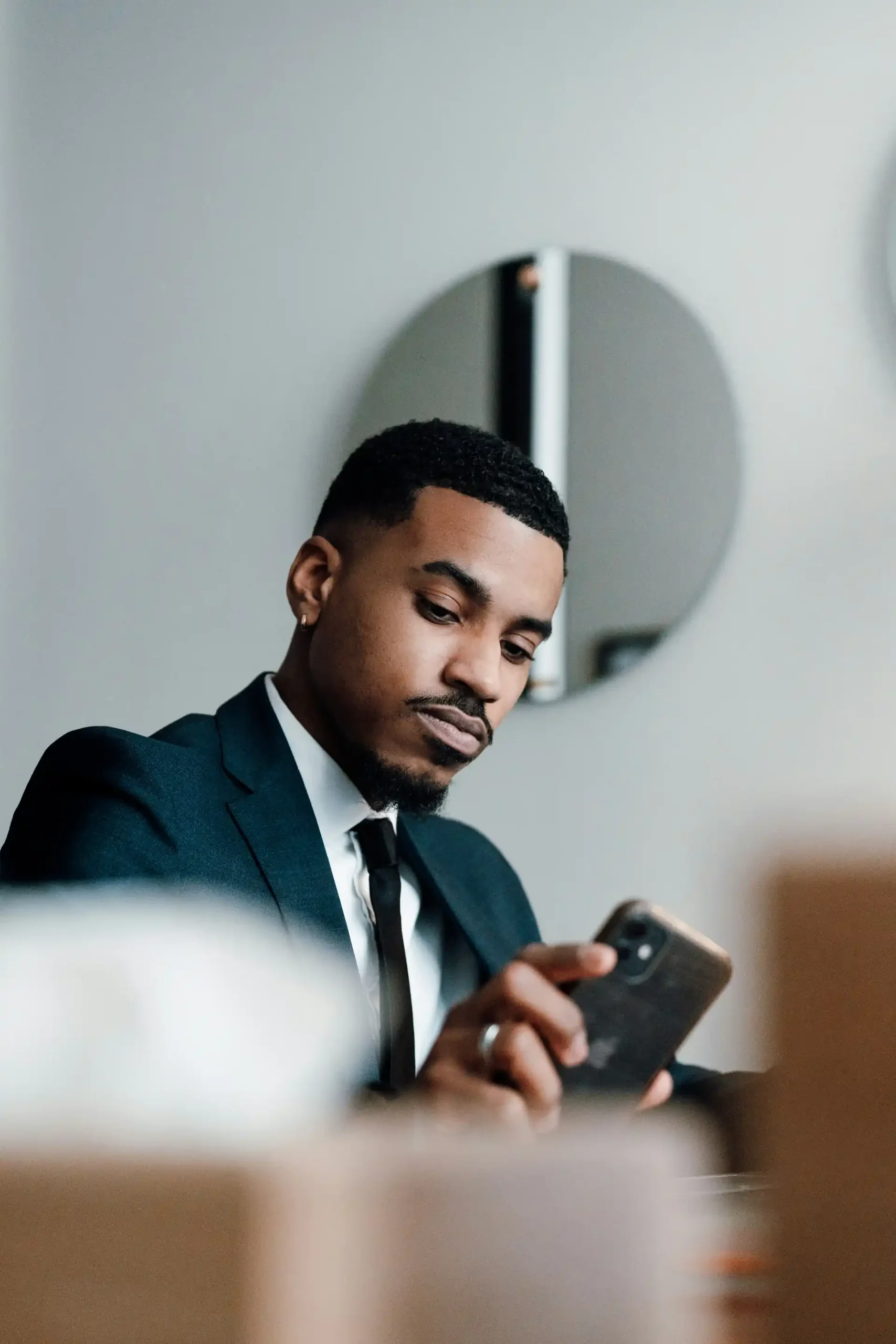 Thompson-Roderick-solicitors-008 Man in a suit checking his phone