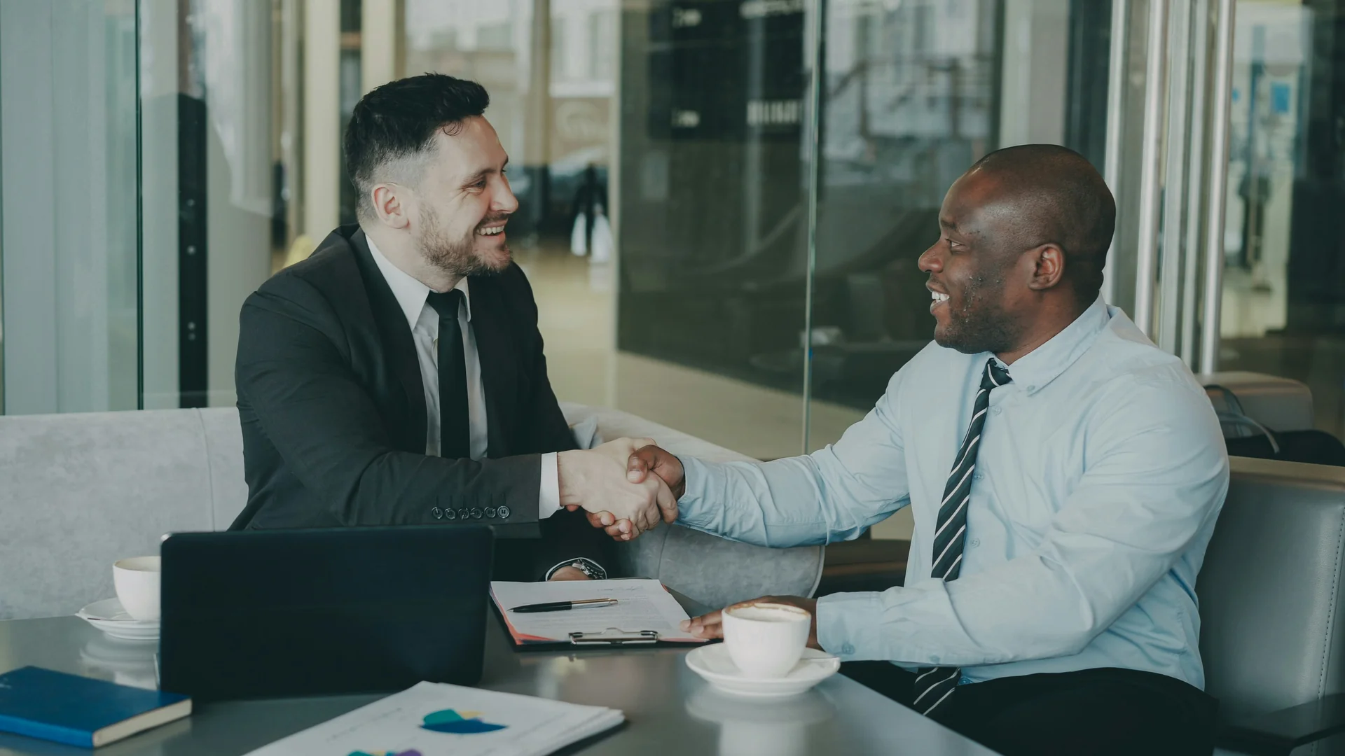 Two people shaking hands during a business meeting